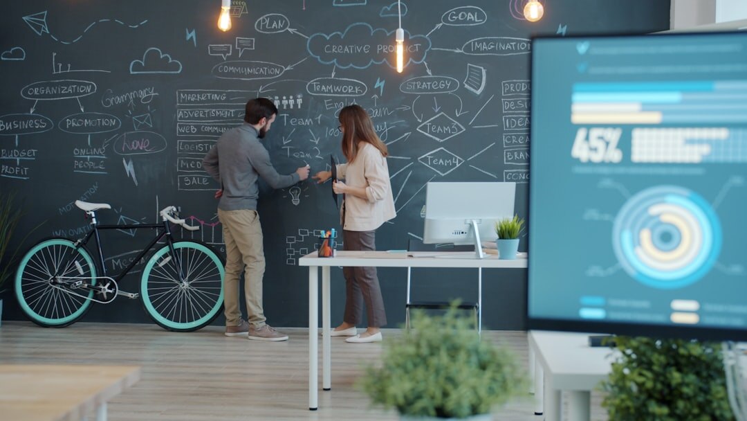 Team analyzing digital marketing analytics dashboards on multiple screens in a modern office