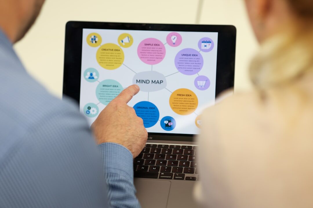 Two colleagues reviewing marketing analytics together on a laptop screen