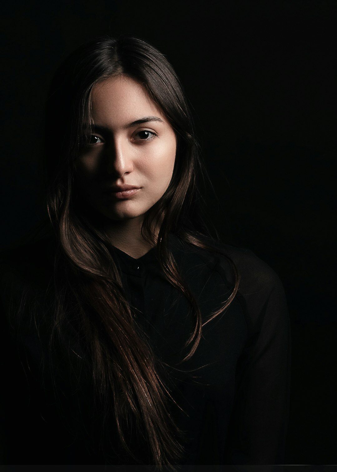 Studio portrait of a woman with long straight hair in a blazer